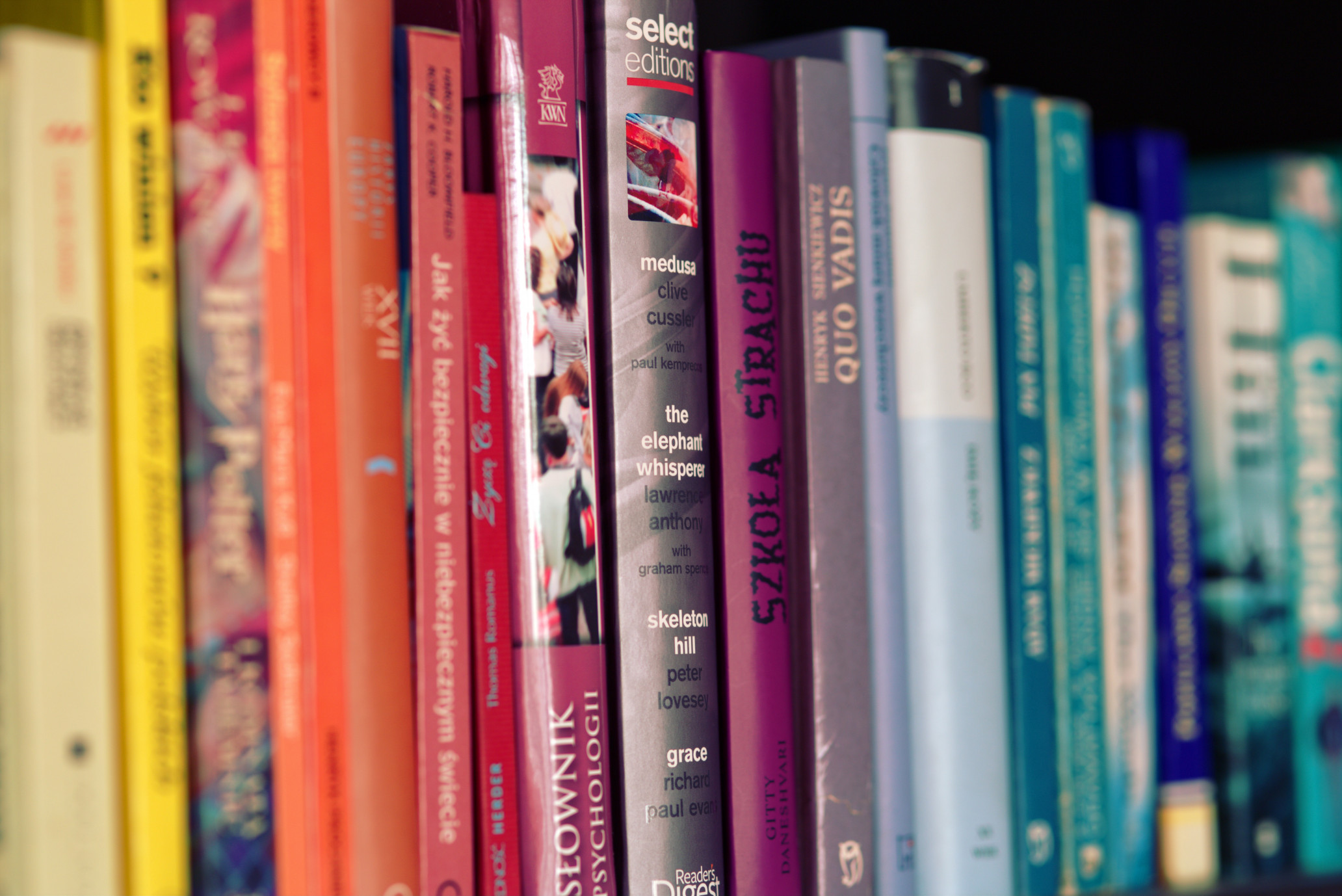 A close-up of well-used books arranged on a shelf