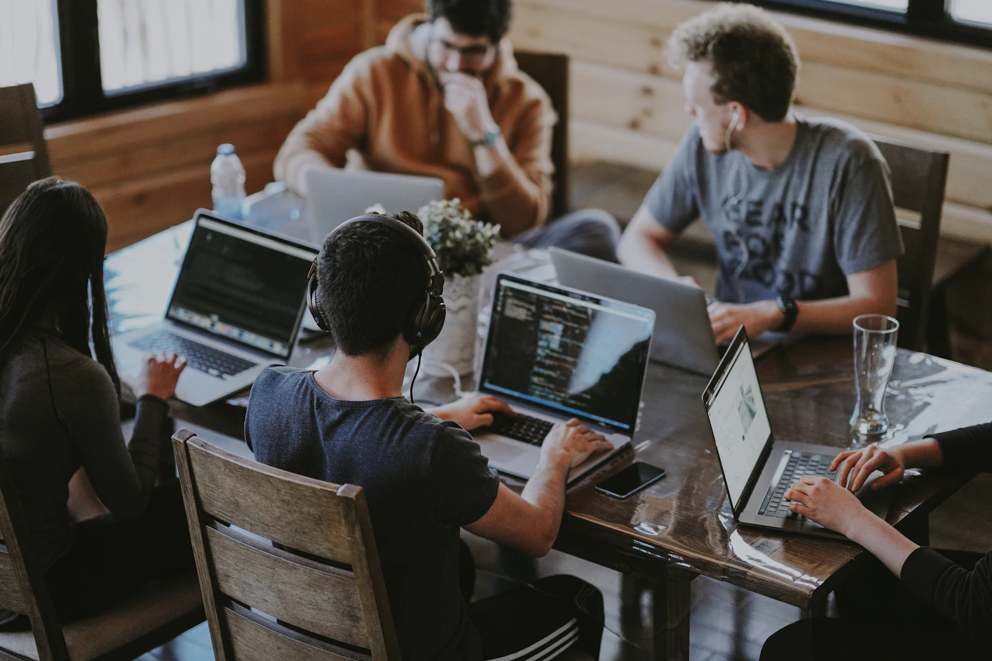 A team working together around a shared table in a bright office.